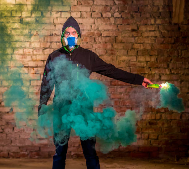 istock Young Guy In Gas Mask With Smoke Grenade In Hand 813081450