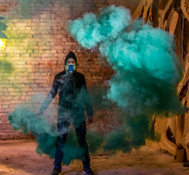 istock Young Man In Gas Mask With Smoke Grenade In Hand 813081496