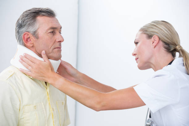 istock Doctor examining patient wearing neck brace 813085316