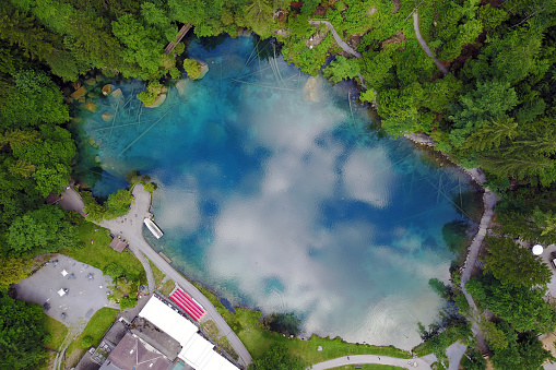Aerial image of Blausee (Blue Lake) a small mountain lake in Kander Valley in Bernese Oberland, Switzerland