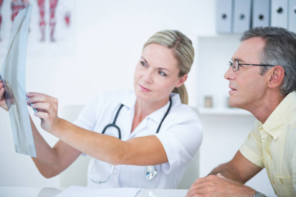 istock Doctor showing X rays to her patient 813085786