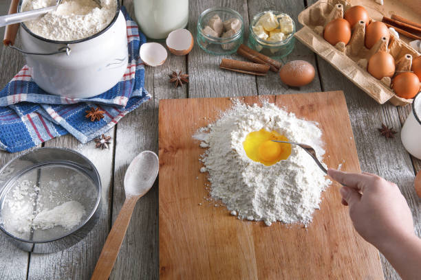 istock Woman baker makes dough with eggs, butter and flour 813086618