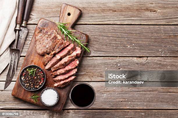 Grilled Beef Steak With Spices On Cutting Board Stock Photo - Download Image Now - Steak, Grilled, High Angle View