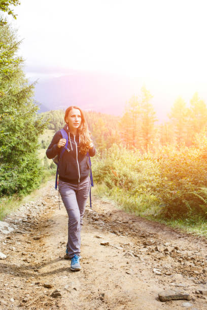 istock Young backpacker woman enjoying mountain trip 813087088