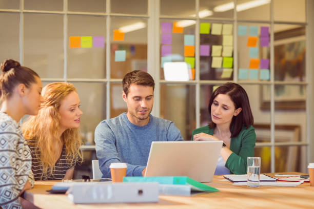 istock Group of young colleagues using laptop 813087434