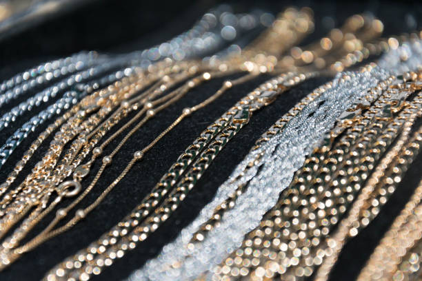 銀と金のネックレスやブレスレットの黒の背景の上に横たわる - jewelry gem gold reflection ストックフォトと画像