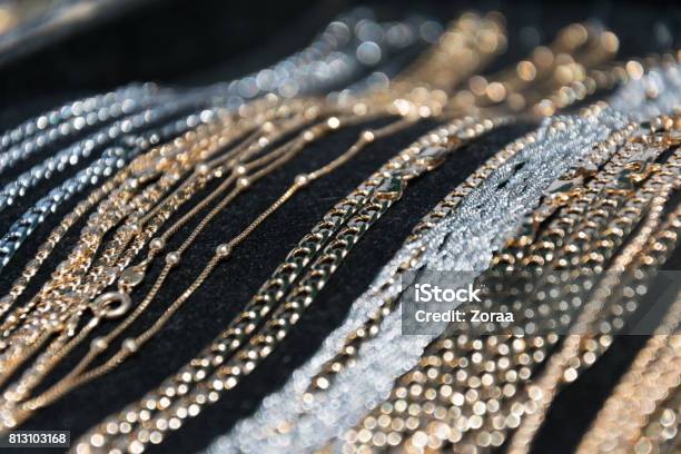 Silver And Gold Necklaces And Bracelets Lying On Black Background Stock Photo - Download Image Now