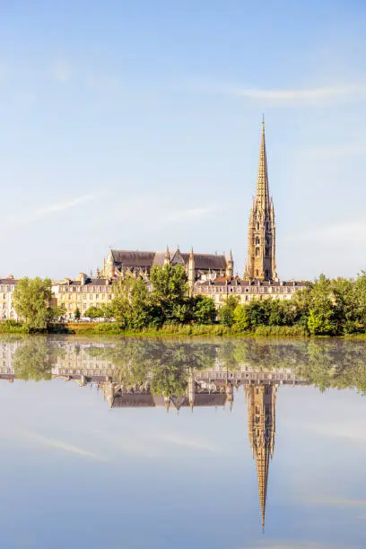 Riverside view on Garonne river with saint Michel cathedral in Bordeaux city, France
