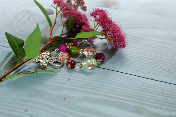 Close up bracelet with leaf shaped gems on wrist concept photo. Simple jewelry. First view person photography with blurry background. High quality picture for wallpaper, travel blog, magazine, article