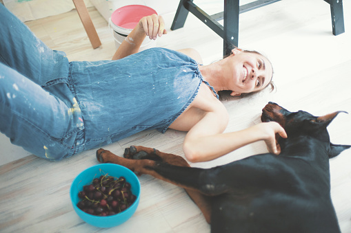 Woman relaxing with dog at home.