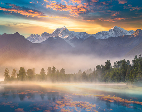 Mount Cook and Mount Tasman reflected in Lake Matheson at Sunset. New Zealand