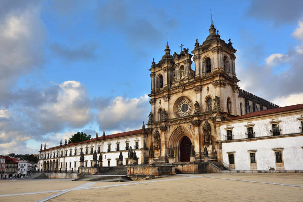 The Alcobaca Monastery is a Mediaeval Roman Catholic monastery located in the town of Alcobaca  shown at sunset. The church and monastery were the first Gothic buildings in Portugal