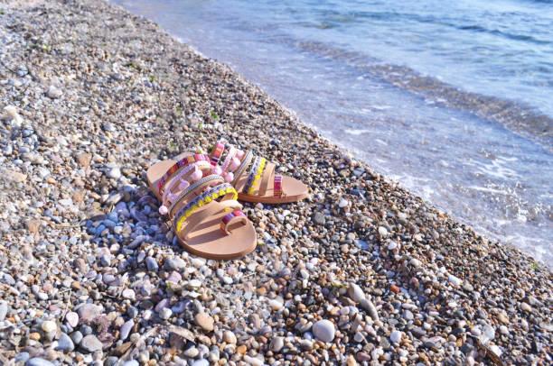 istock greek sandals on the beach 813128936