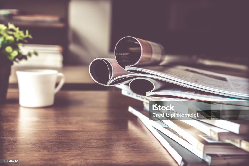 selective focus of  stacking magazine place on table in living room selective focus of the stacking magazine place on table in living room Magazine - Publication Stock Photo