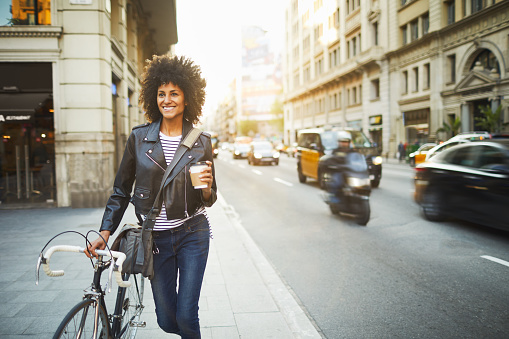 Young hipster woman in the streets of Barcelona commuting. Mixed race model, spanish and Ethiopian.
