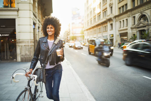 young hipster woman in the streets of barcelona commuting. - casaco de couro imagens e fotografias de stock