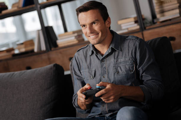 istock Joyful nice guy enjoying his hobby at home 813145104