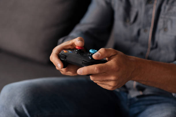 istock Careful quick witted man holding gaming gear 813145224
