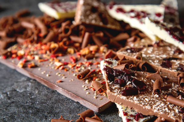 istock White, milky, dark chocolate with berries. Dark background. 813146728