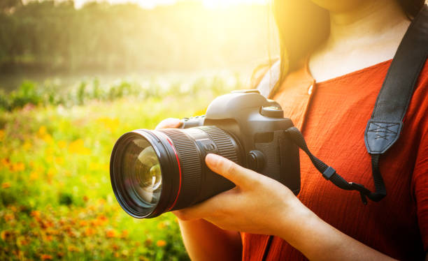 istock woman hand holding a camera 813155754