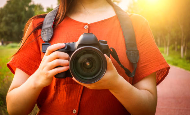 istock woman hand holding a camera 813155758