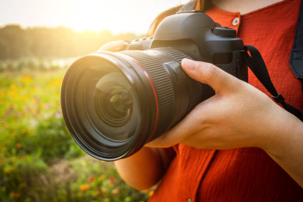 istock woman hand holding a camera 813155898