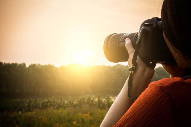 istock woman hand holding a camera 813155912
