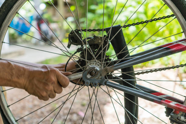 istock close-up of mechanic setting up chain on bicycle in workshop 813160324