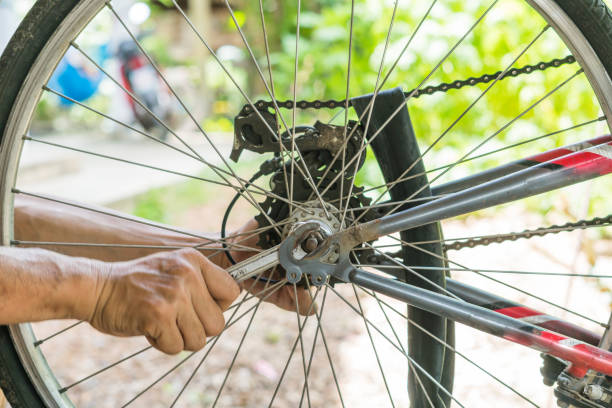 istock close-up of mechanic setting up chain on bicycle in workshop 813160372