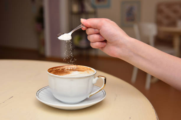 istock The girl's hand pours sugar 813160886