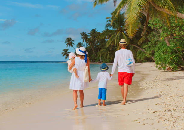 istock happy family with kids walk on beach 813163642
