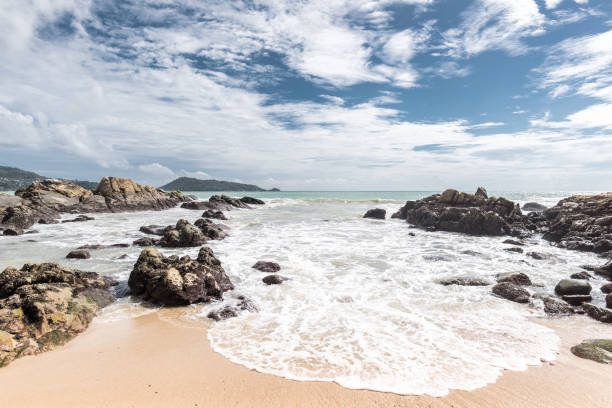 istock Beautiful beach with stone in the morning 813166750