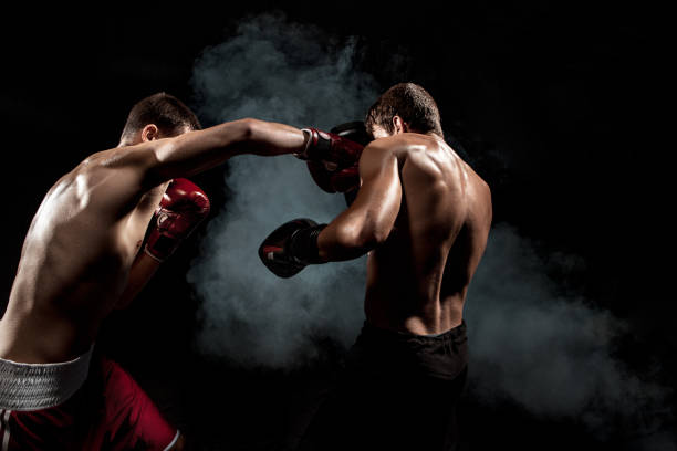 istock Two professional boxer boxing on black smoky background 813176324