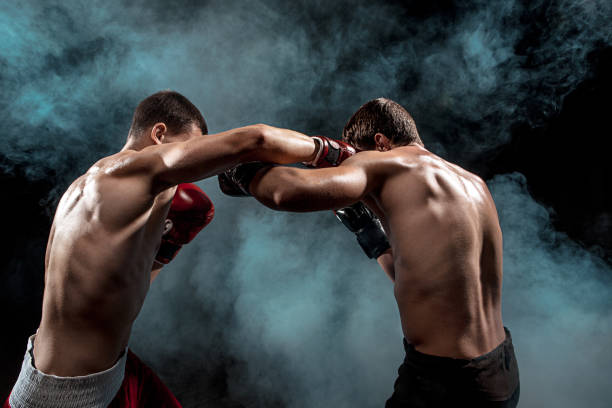 istock Two professional boxer boxing on black smoky background 813177142