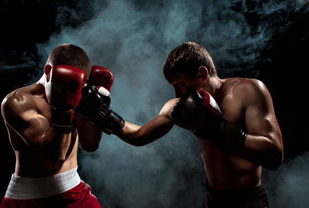 istock Two professional boxer boxing on black smoky background 813177836