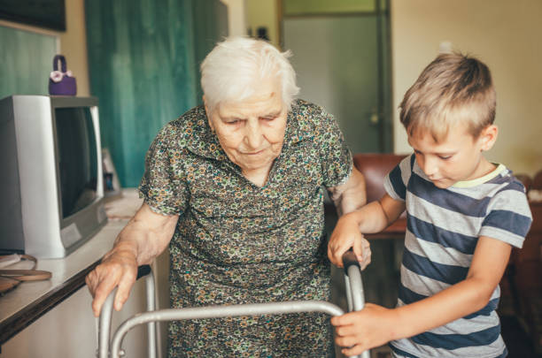 enkel besucht seine oma im kindergarten - great grandmother stock-fotos und bilder