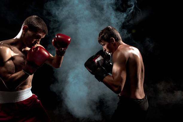 istock Two professional boxer boxing on black smoky background 813179190