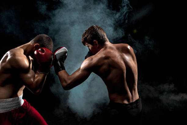 istock Two professional boxer boxing on black smoky background 813180404