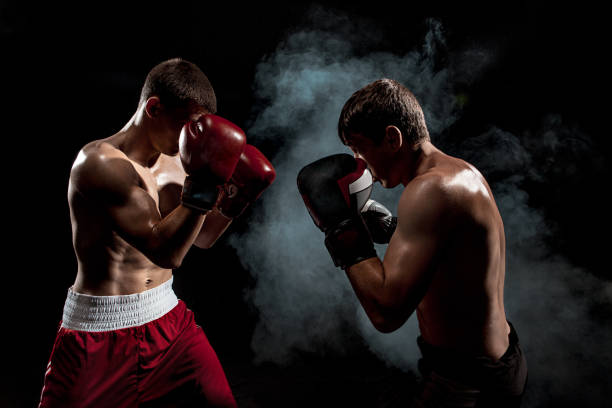 istock Two professional boxer boxing on black smoky background 813182500