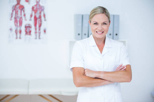 istock Happy doctor looking at camera with arms crossed 813183746
