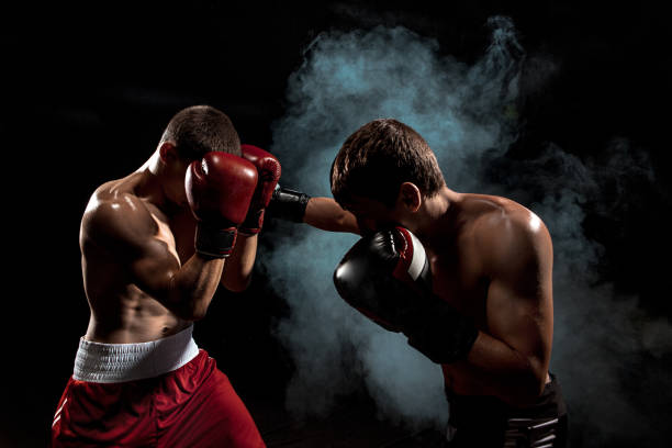 istock Two professional boxer boxing on black smoky background 813186668