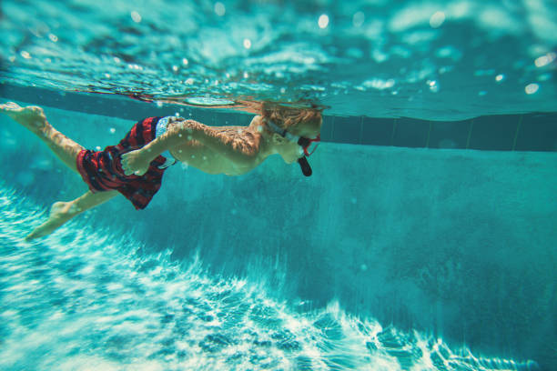 istock little boy swimming underwater, active kids 813192342