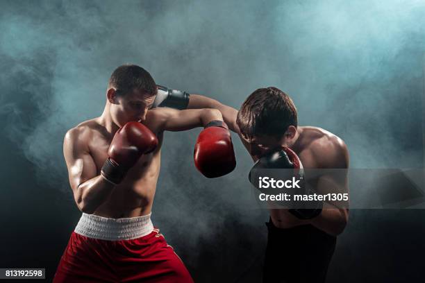 Two Professional Boxer Boxing On Black Smoky Background Stock Photo - Download Image Now