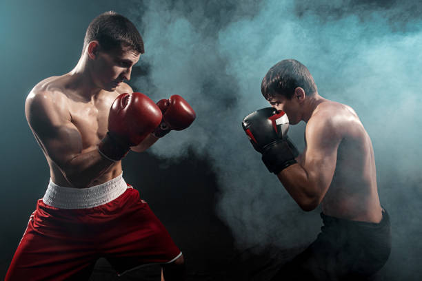 istock Two professional boxer boxing on black smoky background 813192792