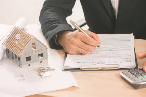 istock Businessman signing a mortgage  contract 813194884