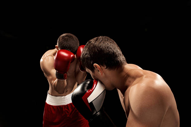 istock Two professional boxer boxing on black background 813195412