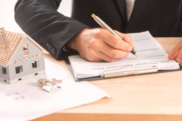 istock Businessman signing a mortgage  contract 813195842
