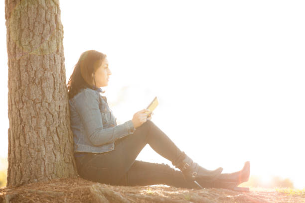 istock One Latin descent woman using digital tablet outdoors in park. 813198262