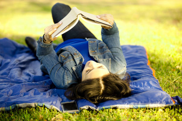 istock One Latin descent woman reading outdoors in park. 813198322