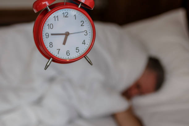istock Young man lying in bed suffering from alarm 813199236